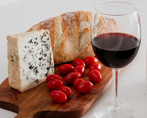 a glass of red wine with apperitive